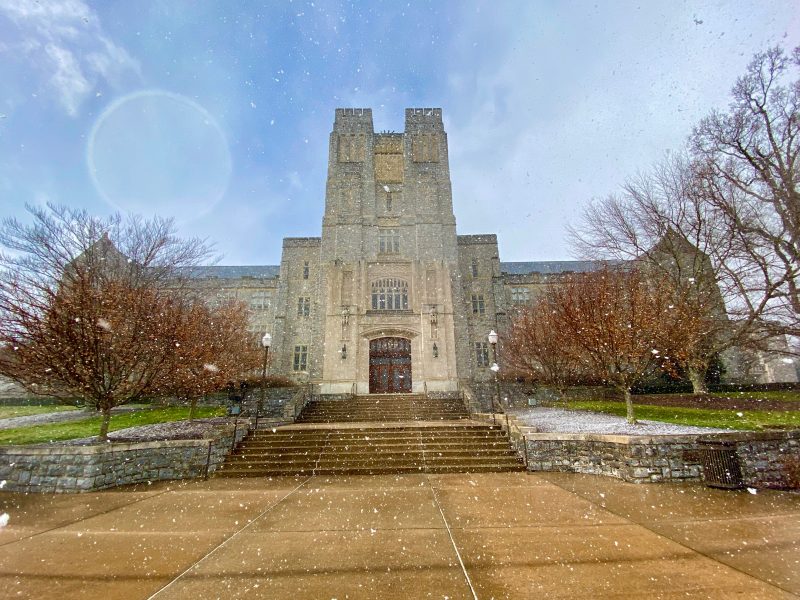 Burruss Hall with sunshine and snow flurries.